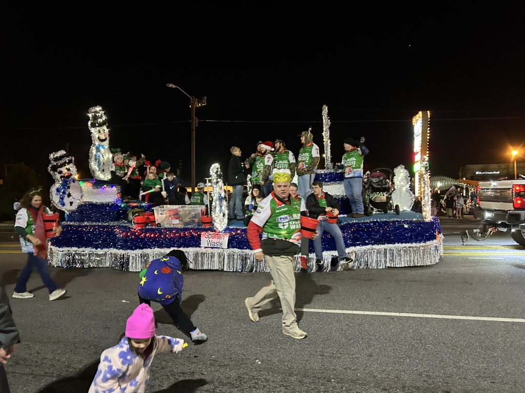 Image of parade float and parade walkers in Spartanburg Christmas Parade.