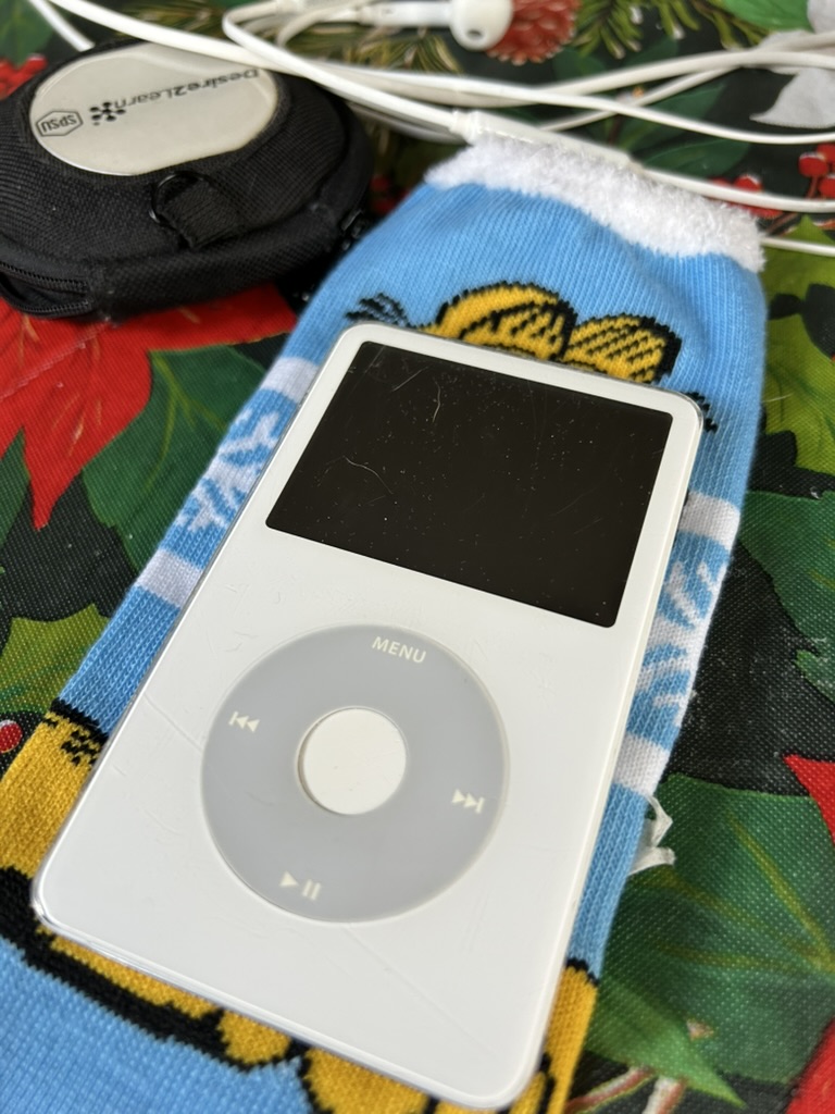 Image of iPod Classic 5.5 gen laying on a Garfield cartoon sock.